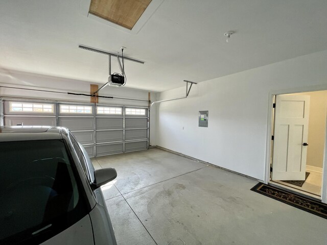 garage with electric panel and a garage door opener