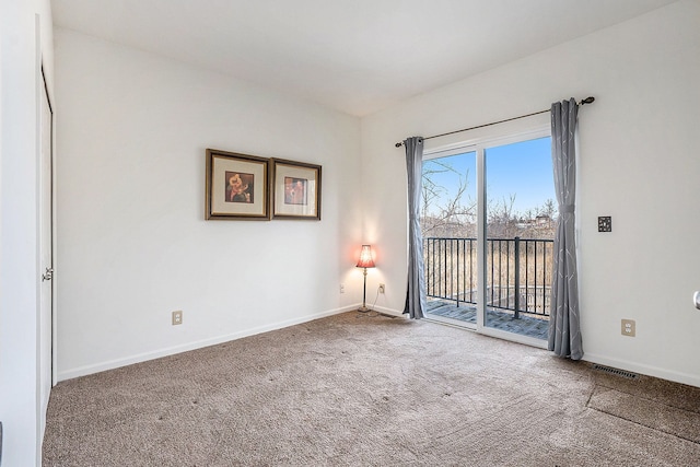 carpeted empty room with visible vents and baseboards