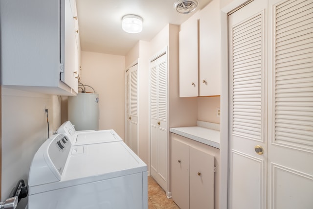 laundry area featuring light tile patterned floors, electric water heater, visible vents, independent washer and dryer, and cabinet space