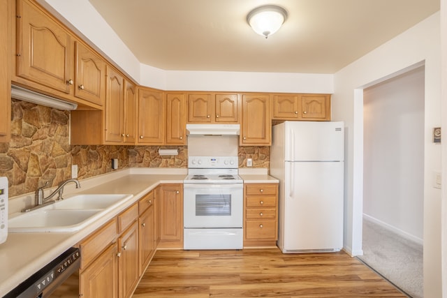 kitchen with light countertops, decorative backsplash, a sink, white appliances, and under cabinet range hood