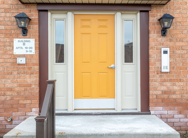 property entrance featuring brick siding