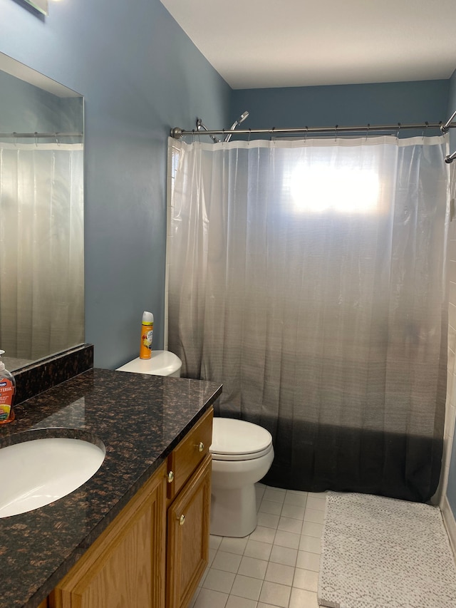 bathroom with vanity, tile patterned floors, toilet, and a shower with shower curtain