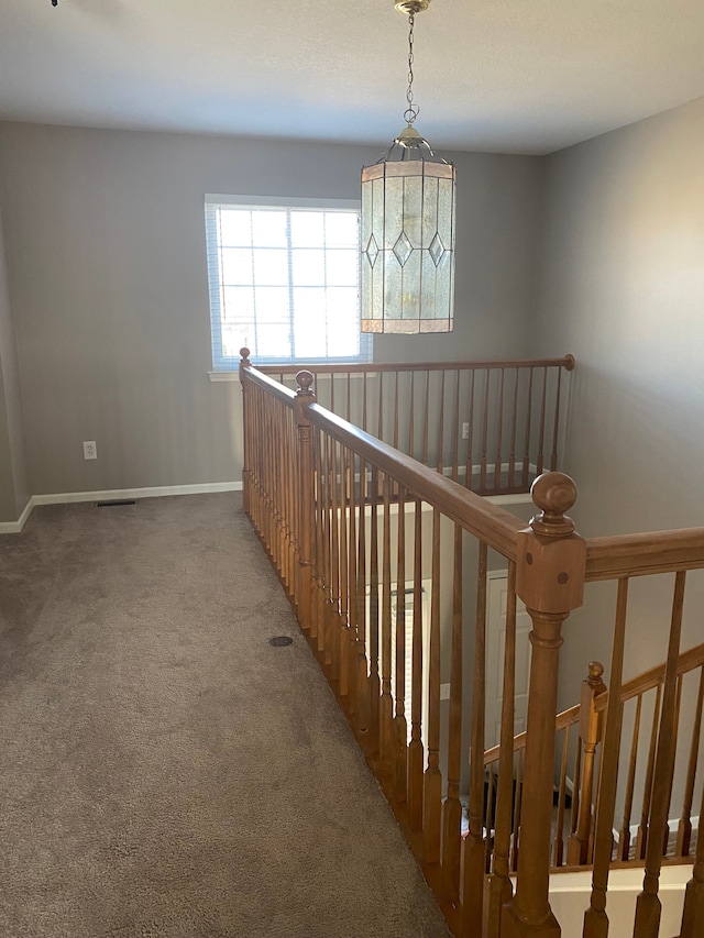 interior space with baseboards, visible vents, and carpet floors