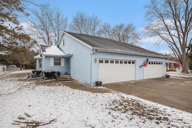 view of snowy exterior featuring driveway