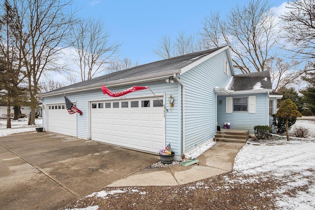 view of property exterior featuring a garage and concrete driveway