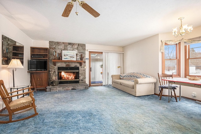 living area featuring baseboards, carpet flooring, a stone fireplace, and a textured ceiling