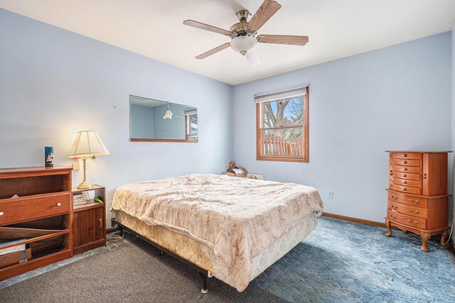 carpeted bedroom featuring ceiling fan and baseboards