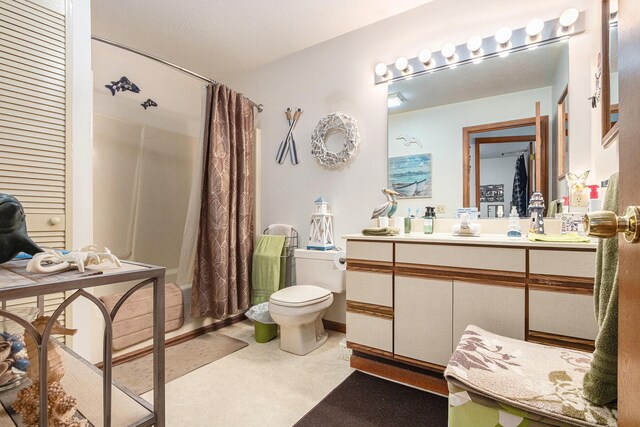 bathroom featuring shower / bath combo, vanity, and toilet