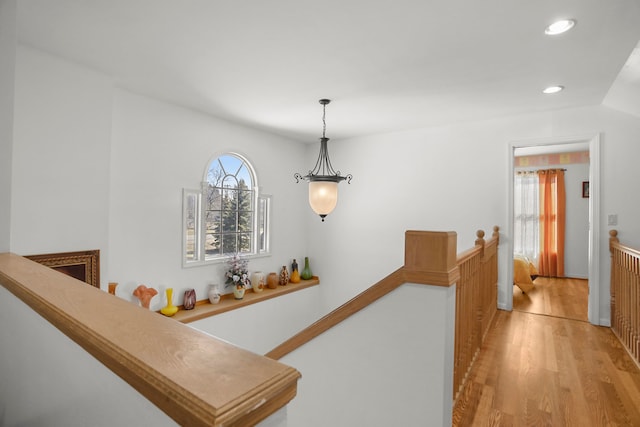 hall featuring an upstairs landing, recessed lighting, and light wood finished floors