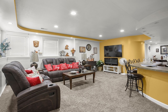 living room featuring carpet flooring, recessed lighting, visible vents, and baseboards