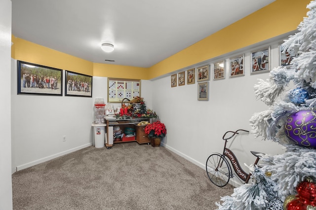 recreation room with baseboards and carpet floors