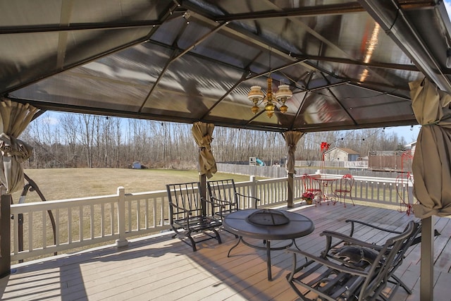 wooden terrace with a gazebo and a trampoline