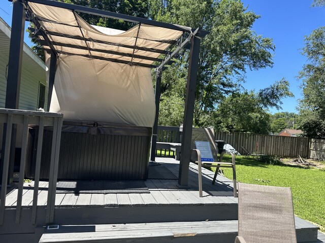 wooden deck featuring a yard, a pergola, fence, and a hot tub