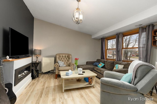 living room with a fireplace and wood finished floors