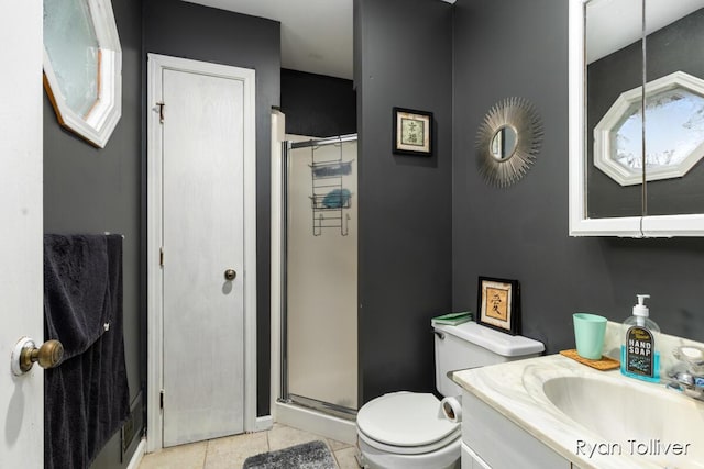 full bath with a stall shower, tile patterned flooring, vanity, and toilet