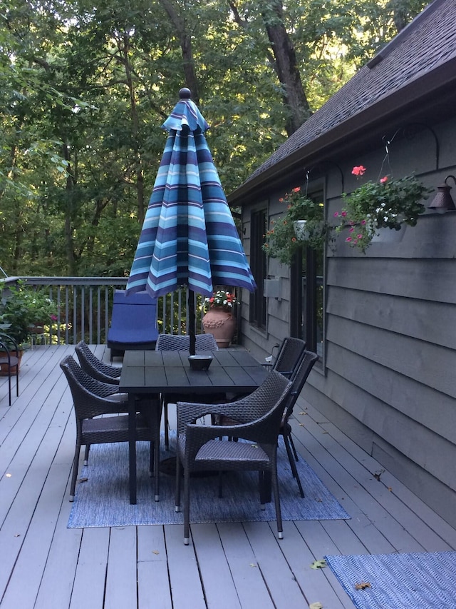 wooden terrace with outdoor dining area