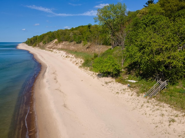 view of street featuring a view of the beach and a water view