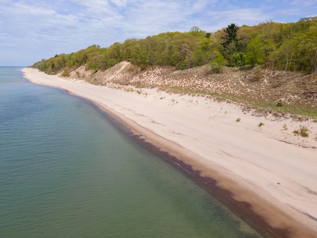 drone / aerial view with a water view and a beach view