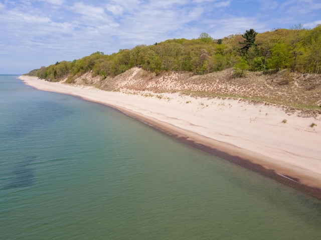 birds eye view of property featuring a beach view and a water view