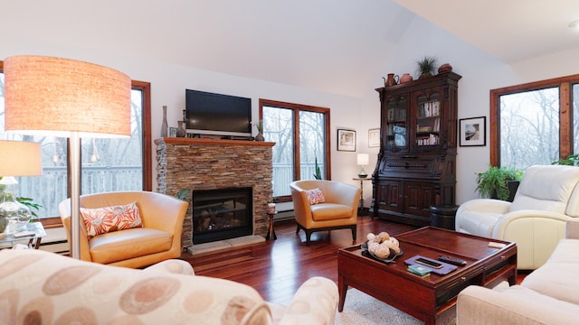 living area with vaulted ceiling, a fireplace, and wood finished floors