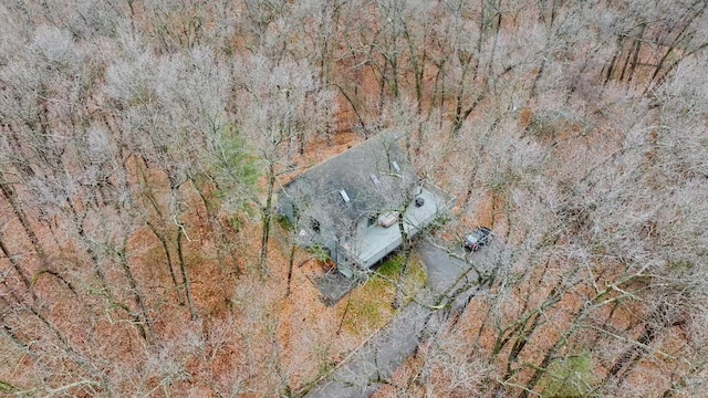 drone / aerial view featuring a wooded view