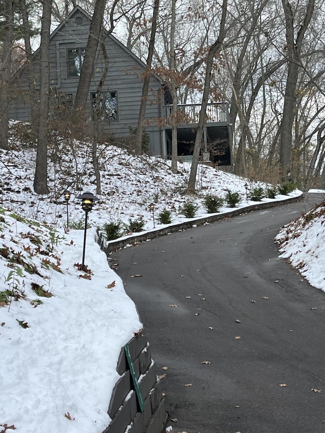 view of snow covered exterior with a wooden deck