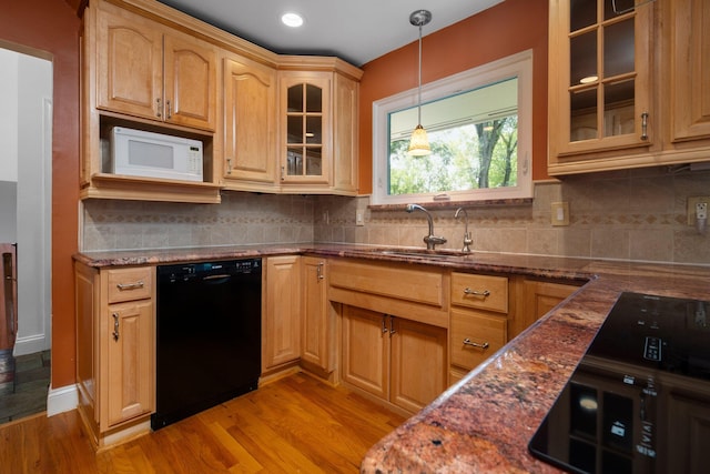 kitchen with white microwave, a sink, light wood-style floors, hanging light fixtures, and dishwasher