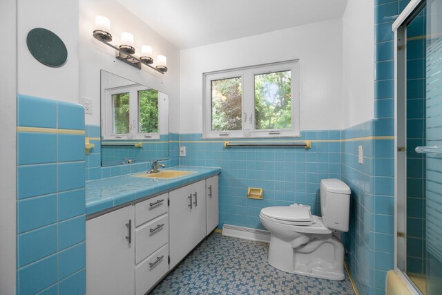 full bath featuring toilet, an enclosed shower, a wealth of natural light, and vanity