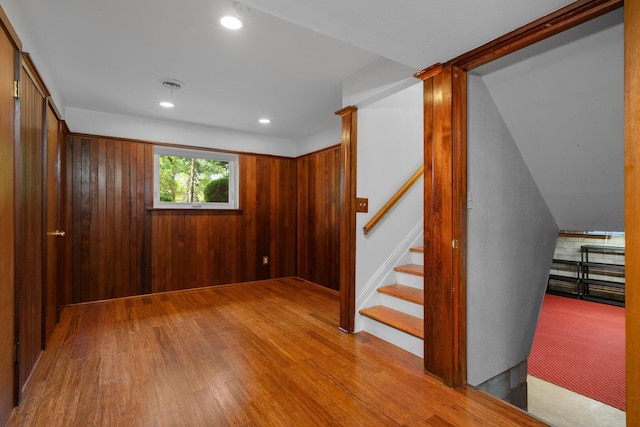 interior space with recessed lighting, visible vents, wood walls, wood finished floors, and stairs