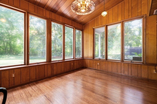 unfurnished sunroom with lofted ceiling, wooden ceiling, and a notable chandelier