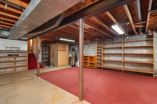 unfinished basement featuring stairs