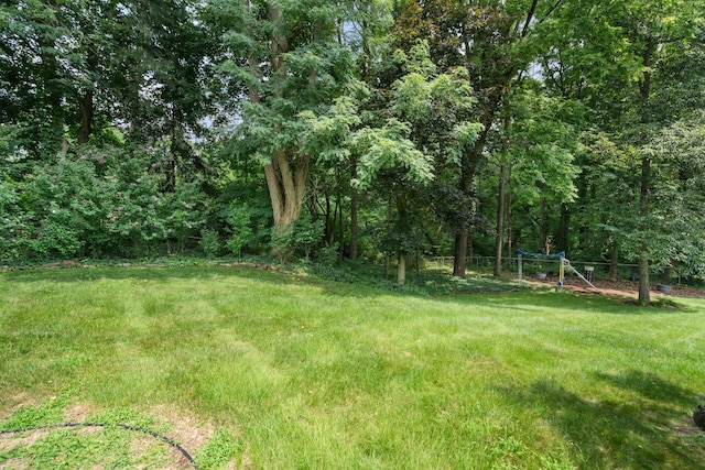 view of yard with fence and a view of trees