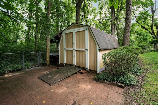 view of shed with a gate and fence