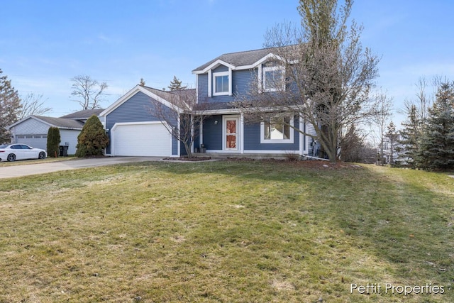 traditional-style house with a garage, concrete driveway, and a front yard