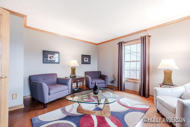 living room with light wood-style floors, ornamental molding, and baseboards