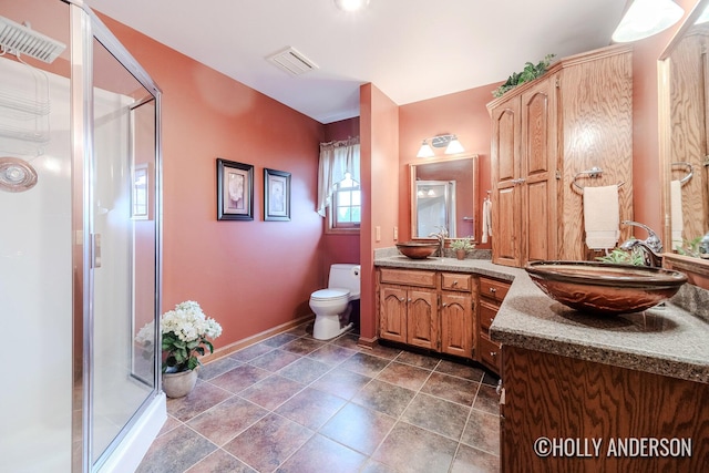 full bathroom with toilet, a stall shower, vanity, and visible vents