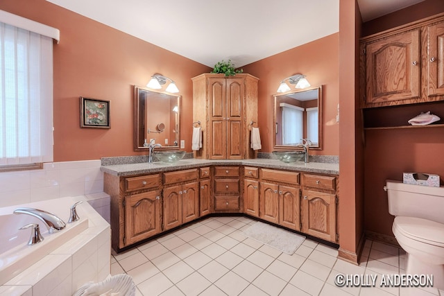 full bathroom featuring a garden tub, double vanity, toilet, a sink, and tile patterned flooring