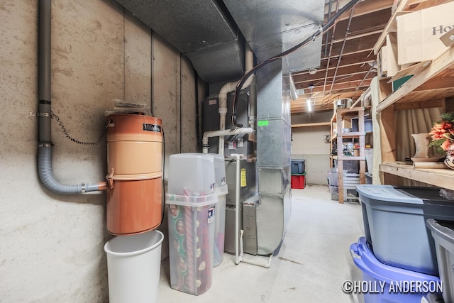 utility room featuring heating unit