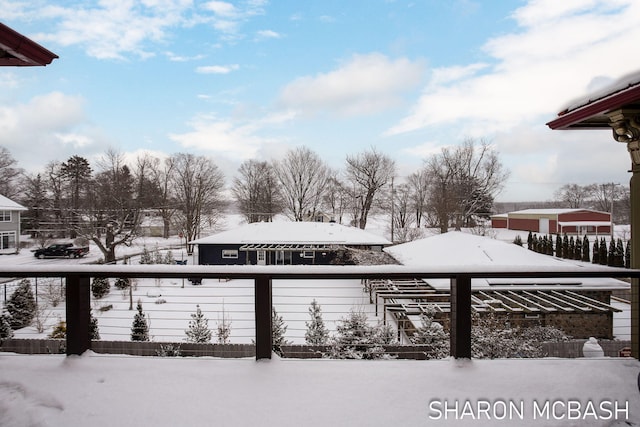 yard layered in snow with a balcony