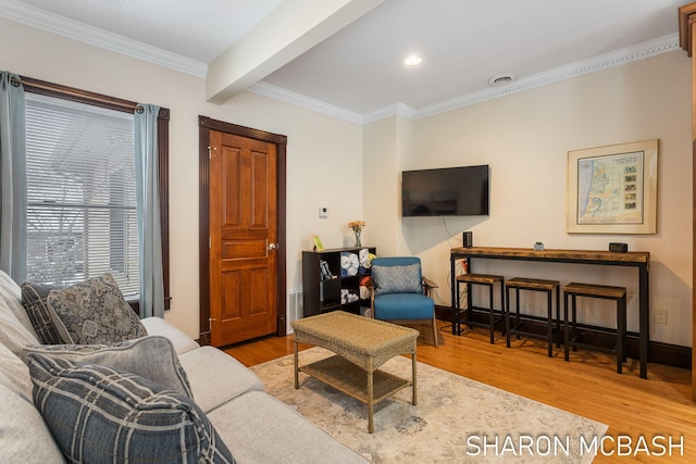 living room with visible vents, ornamental molding, wood finished floors, beamed ceiling, and baseboards