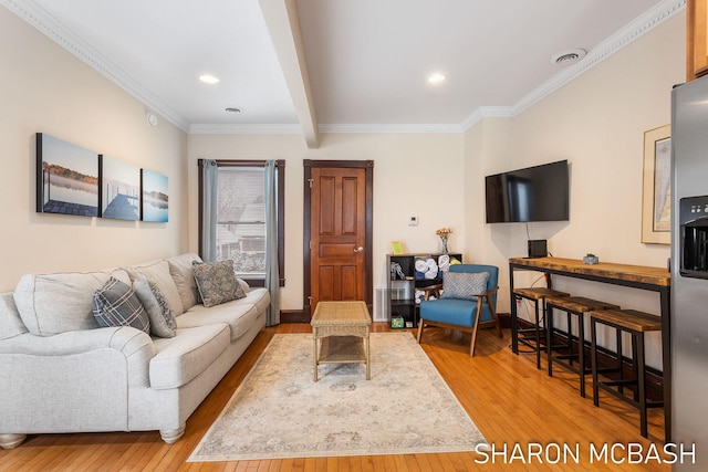 living area featuring beam ceiling, visible vents, ornamental molding, baseboards, and hardwood / wood-style flooring