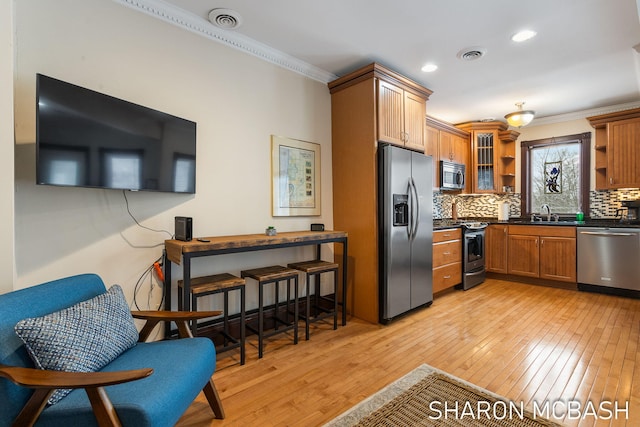 kitchen with crown molding, open shelves, stainless steel appliances, dark countertops, and visible vents