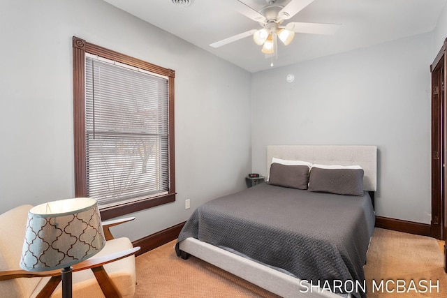 bedroom with a ceiling fan and baseboards