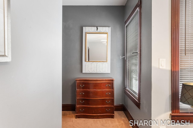 corridor with light colored carpet and baseboards