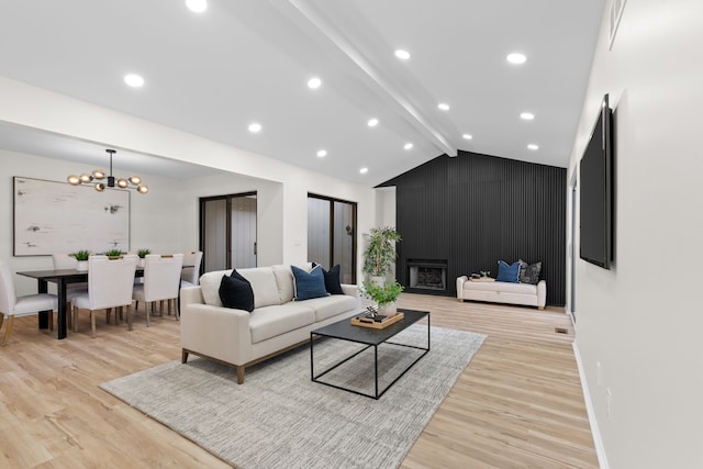 living room featuring baseboards, light wood finished floors, lofted ceiling with beams, recessed lighting, and a chandelier