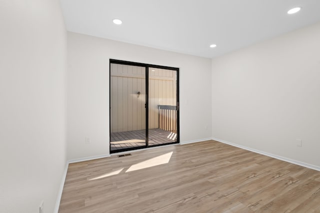 unfurnished room with visible vents, recessed lighting, baseboards, and wood finished floors