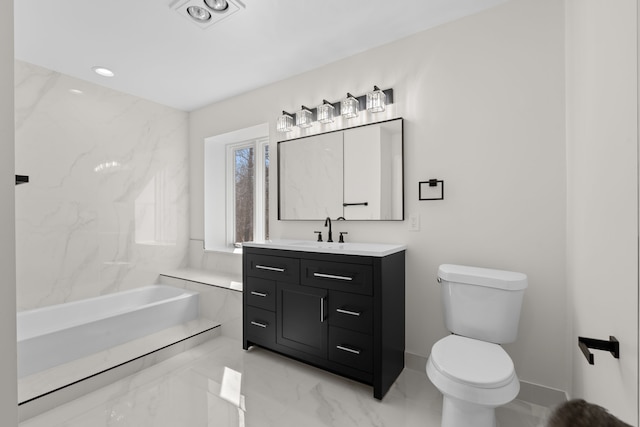 bathroom featuring vanity, toilet, a tub to relax in, and marble finish floor