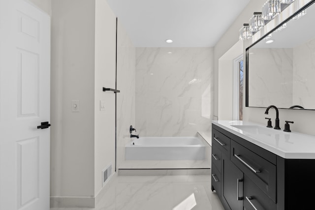 bathroom featuring visible vents, marble finish floor, a bathing tub, recessed lighting, and vanity