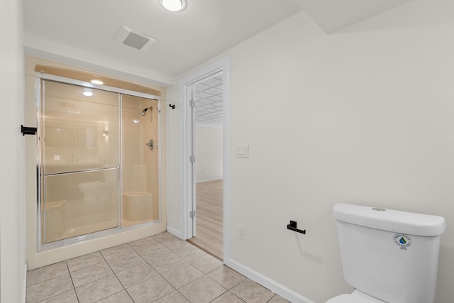 bathroom with tile patterned flooring, visible vents, baseboards, toilet, and a stall shower