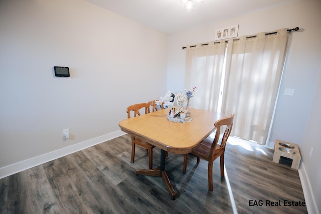 dining space featuring wood finished floors and baseboards